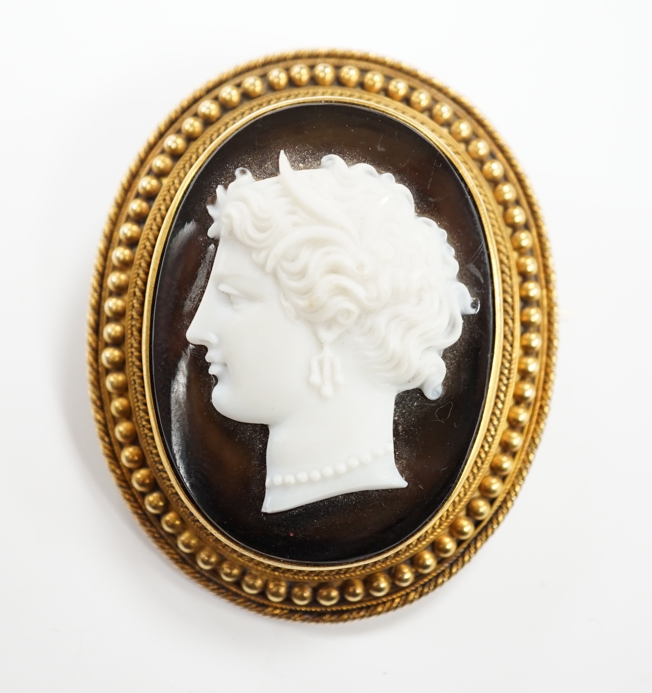 A Victorian yellow metal mounted cameo agate oval brooch, carved with head of a classical goddess to dexter, with beaded border, 49mm